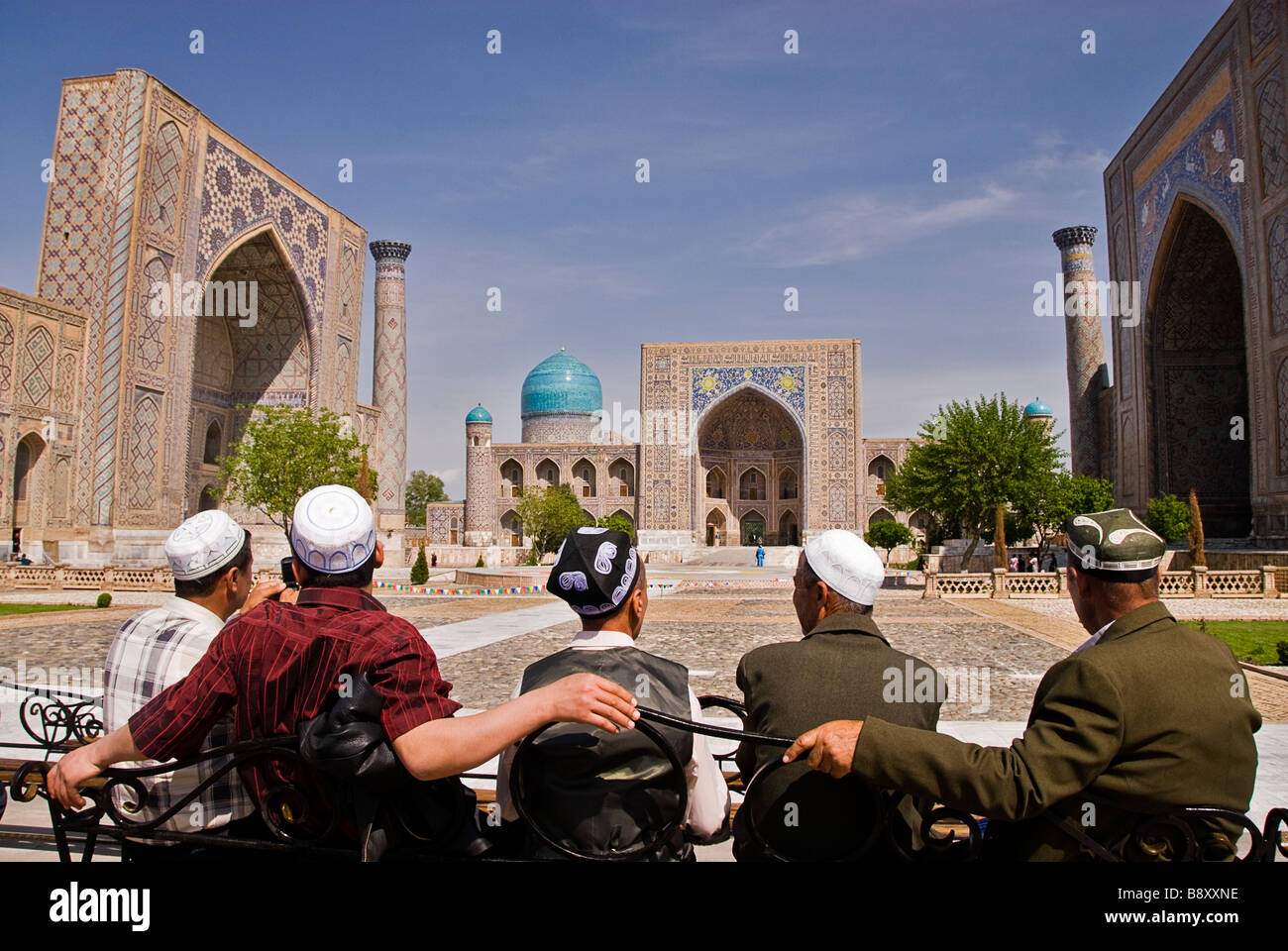 Group of locals in front of the Registan, Samarcand, Uzbekistan, Asia Stock Photo