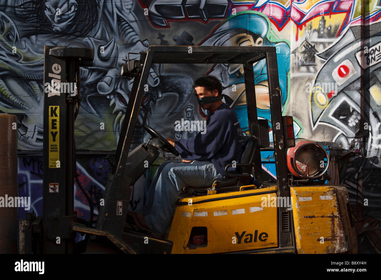 Graffiti Five Points neighborhood Queens New York man driving forklift