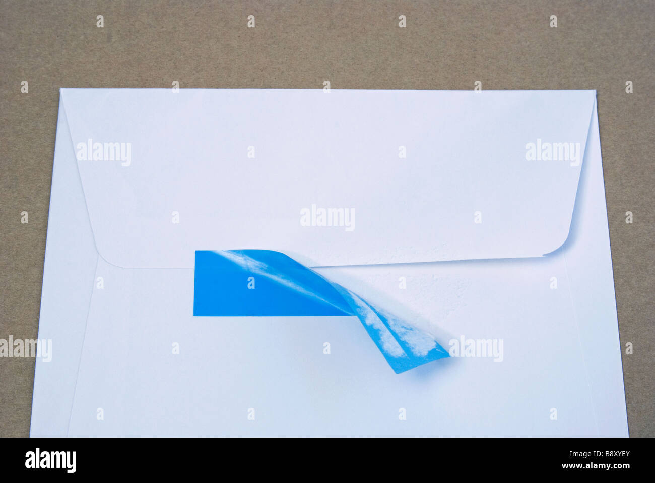 envelope with adhesive tape partially pulled Stock Photo