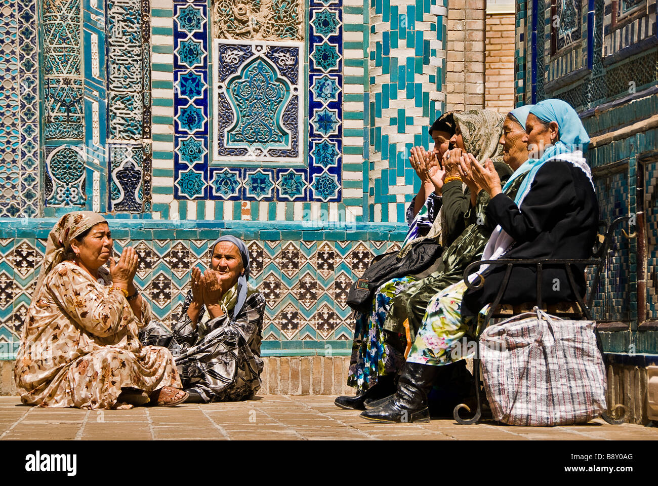 Group of muslim women praying in the Shahr-i-Zindah mausoleum, Samarcand, Uzbekistan Stock Photo