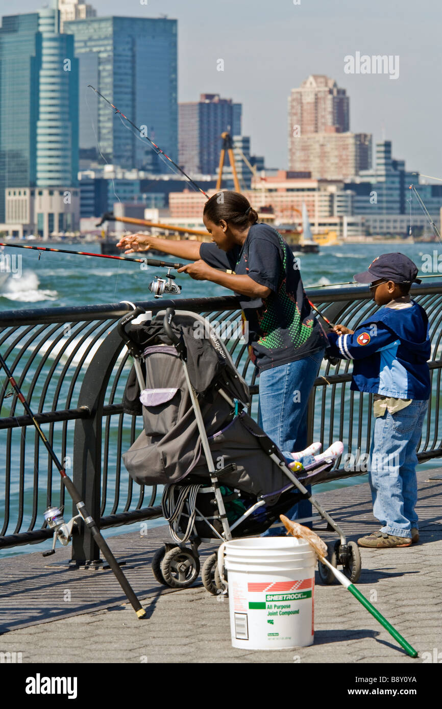 Family fishing in the Hudson River from Battery Park Lower Manhattan