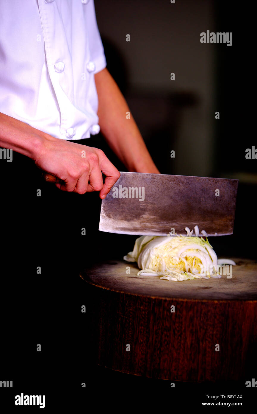 Chef cutting vegetable on the cutting board close up Stock Photo