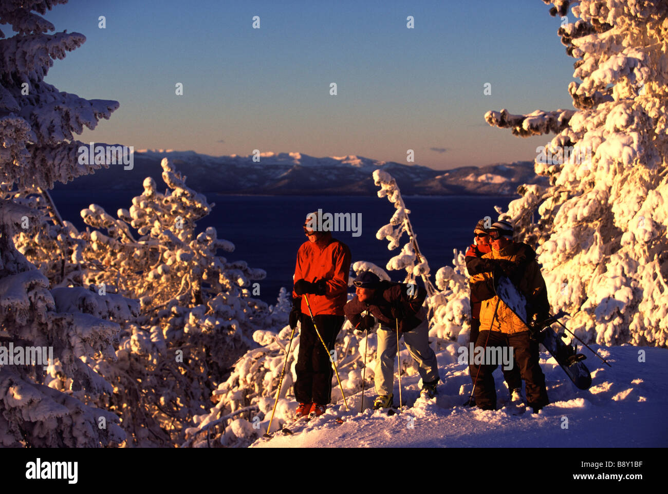Four people skiing at sunrise, Diamond Peak, Nevada, USA Stock Photo