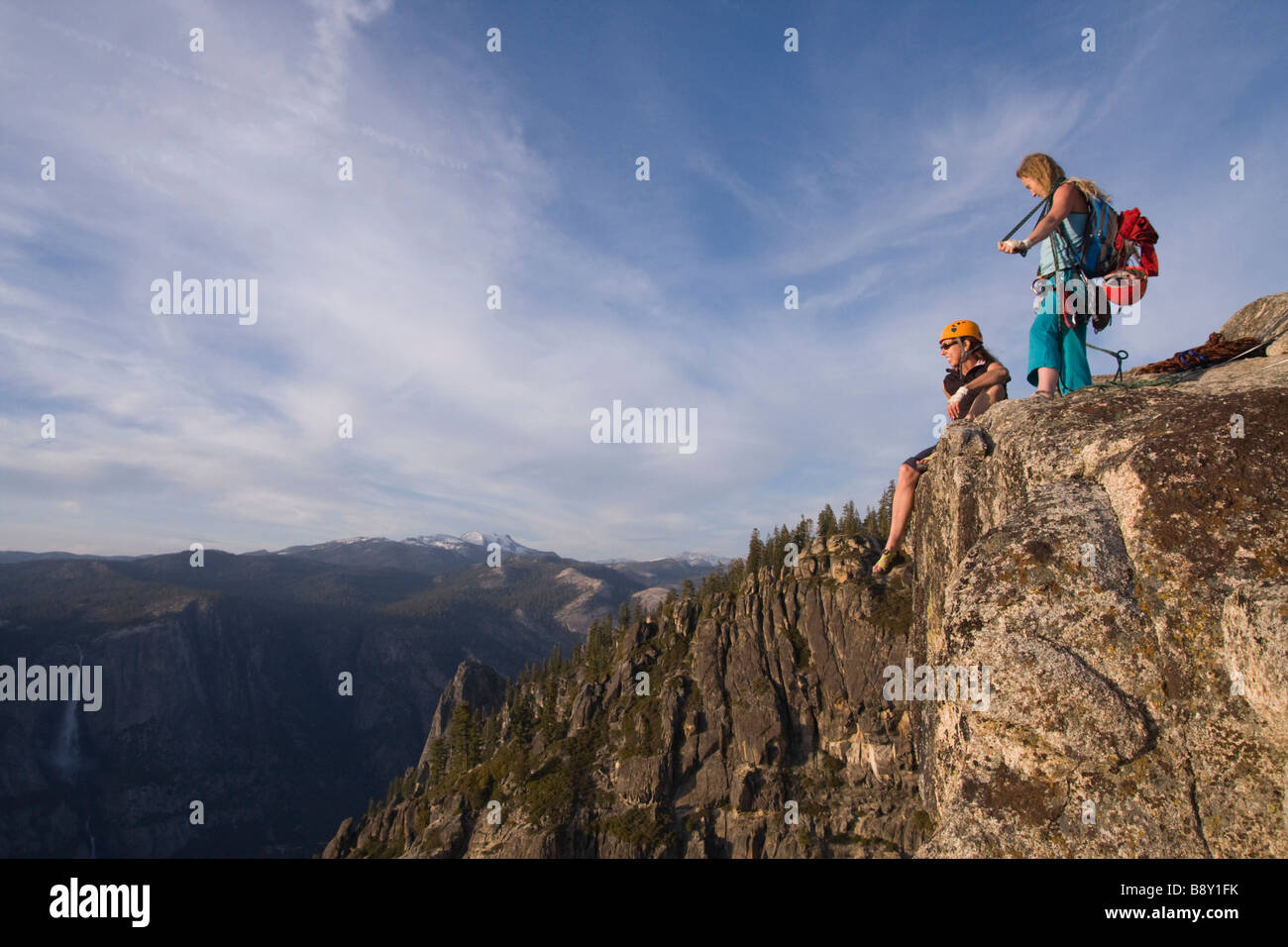 Low angle view of two female rock climbers on an overhanging cliff, Taft Point, Yosemite National Park, California, USA Stock Photo