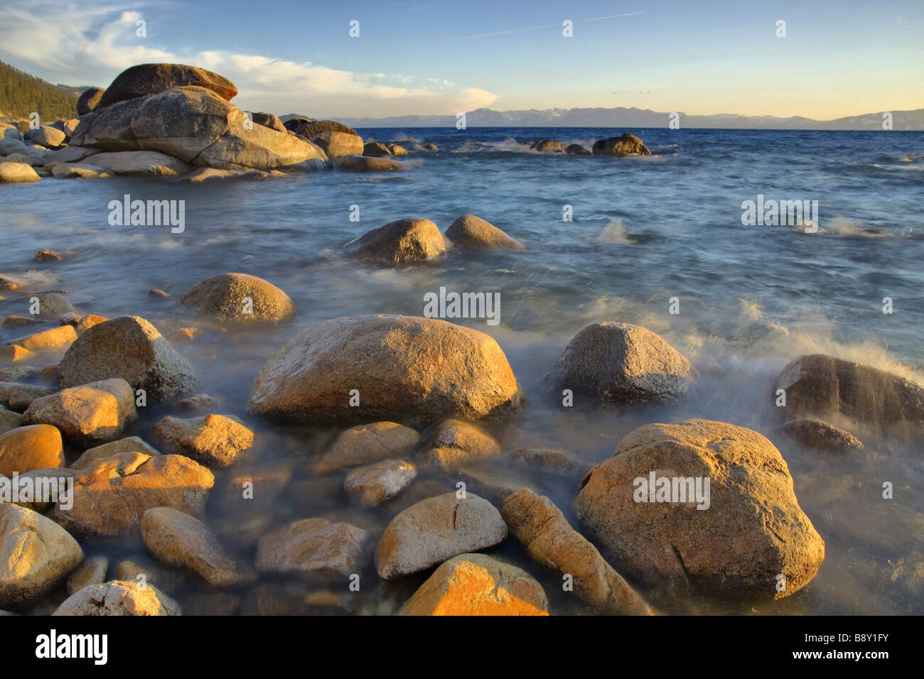 Rocks in a lake at sunset, East Shore, Lake Tahoe, Nevada, USA Stock Photo