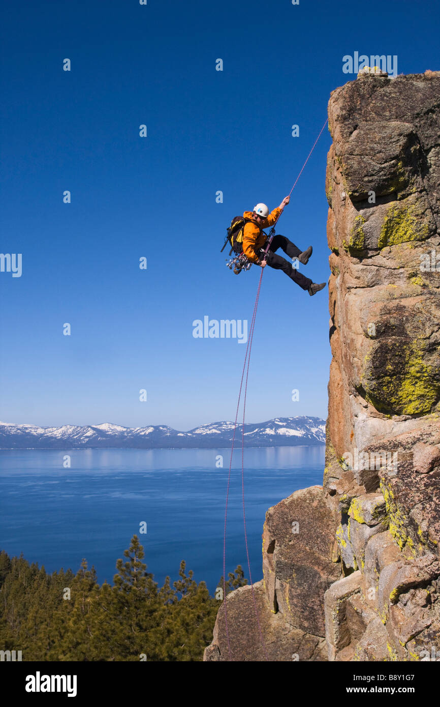 Man rappelling off a cliff, Lake Tahoe, Nevada, USA Stock Photo