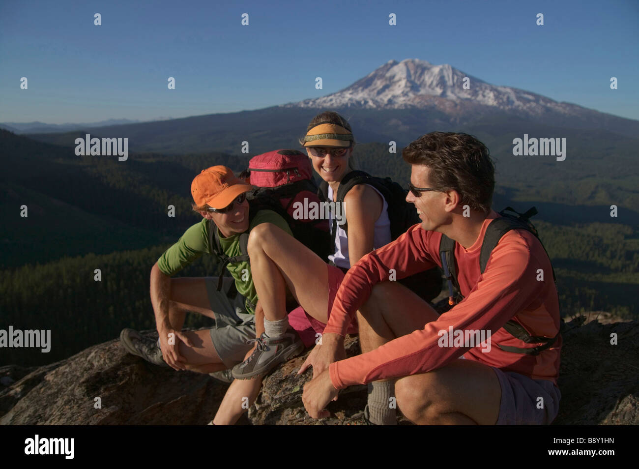 Three hikers on a mountain summit, Mt Adams, Washington State, USA Stock Photo
