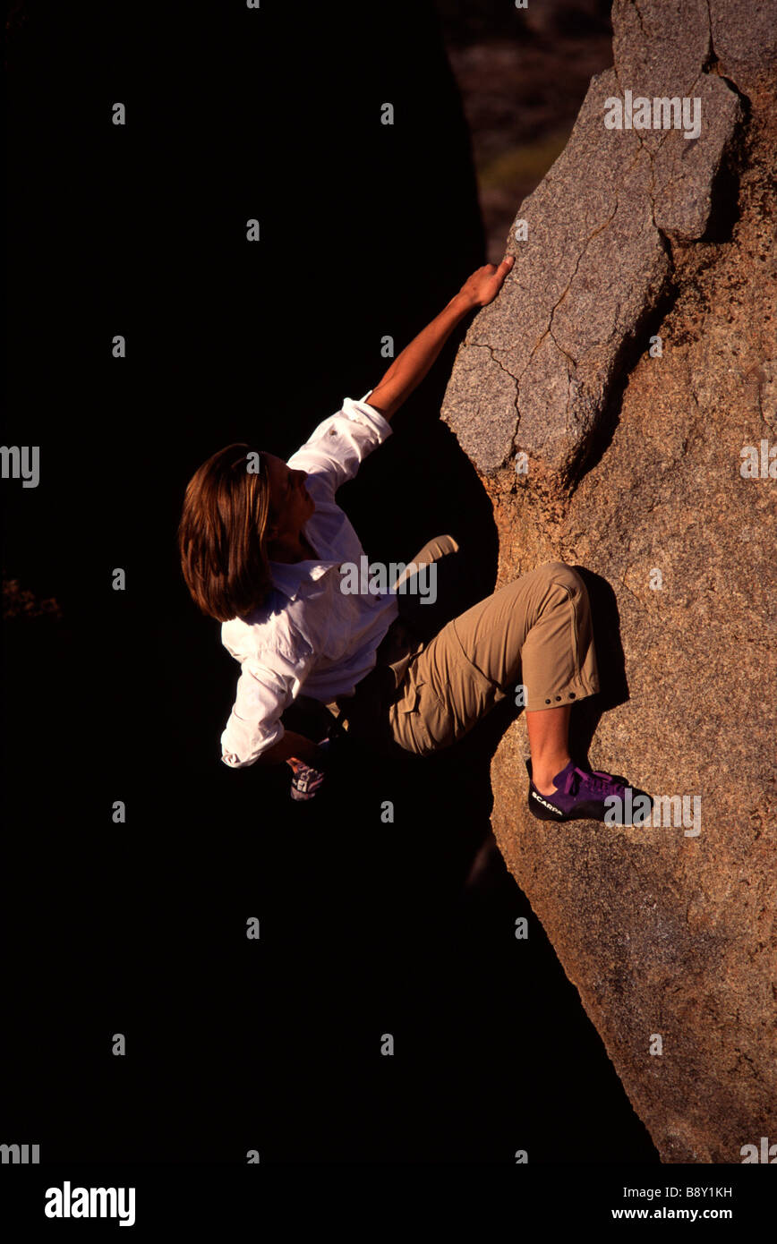 High angle view of a woman climbing a rock, The Buttermilks, California, USA Stock Photo