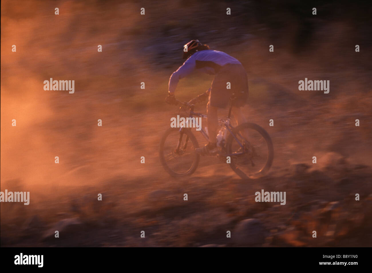 Man riding a mountain bike on a dusty summit, Donner Summit, California, USA Stock Photo