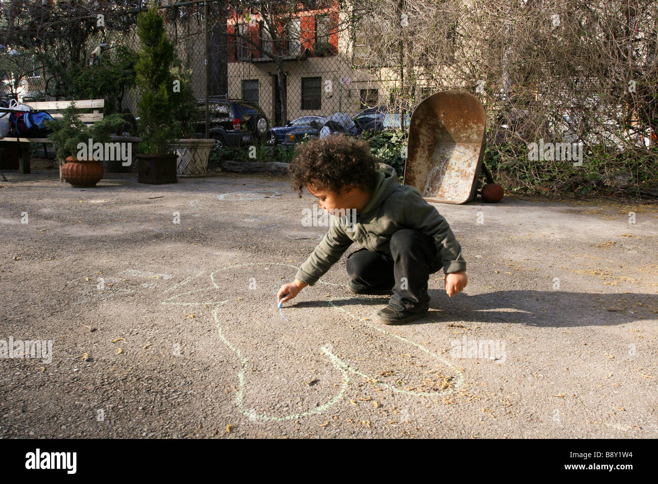 Boy drawing with chalk on a road Stock Photo - Alamy