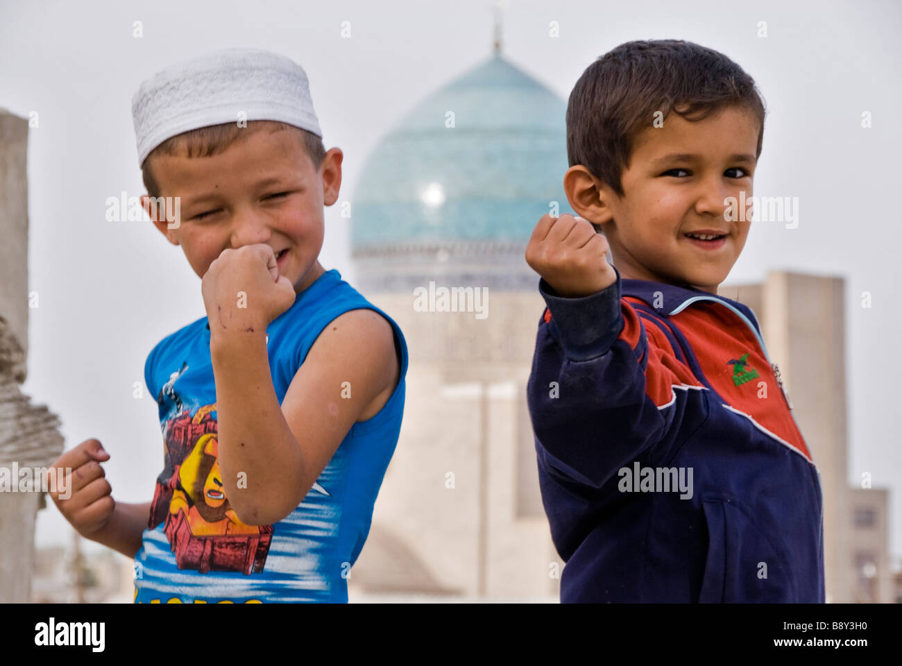 Boys joking to the camera, Bukhara, Uzbekistan, Asia Stock Photo
