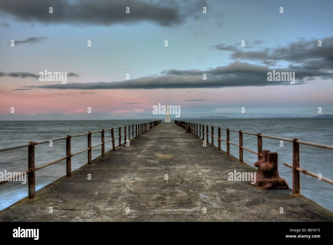 Facing the lighthouse early in the morning at Maryport Stock Photo
