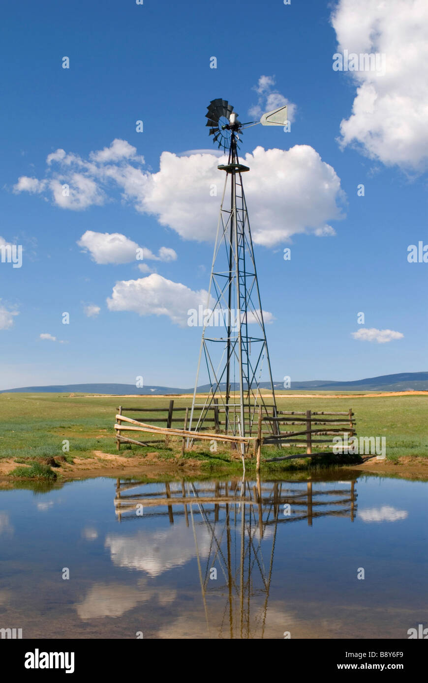 Reflection of an industrial windmill in water, Wyoming, USA Stock Photo