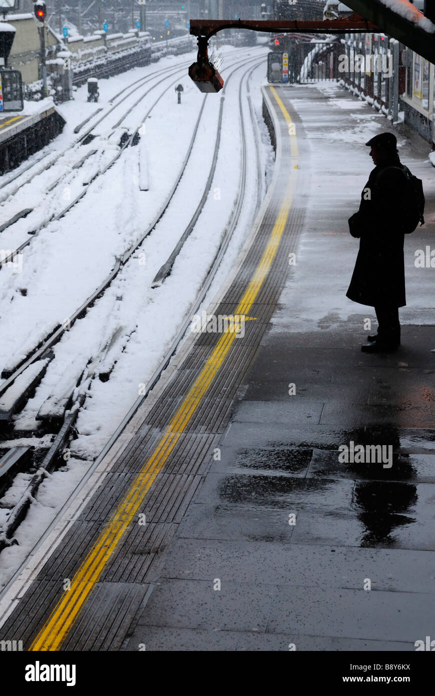 Commuter waiting for an underground train to arrive at Farringdon Tube Station during Stock Photo