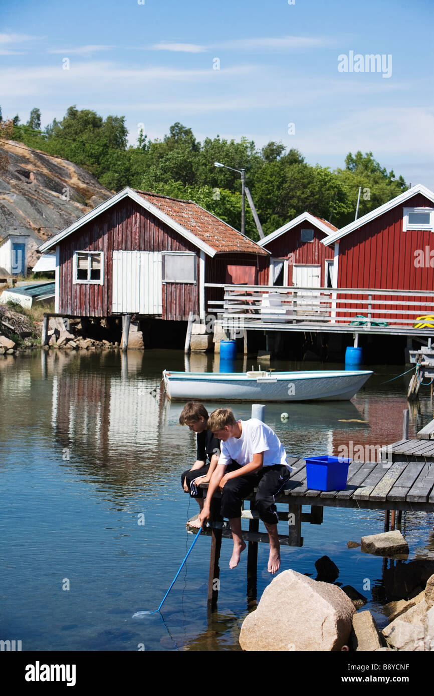 Two boys fishing Smogen Bohuslan Sweden. Stock Photo