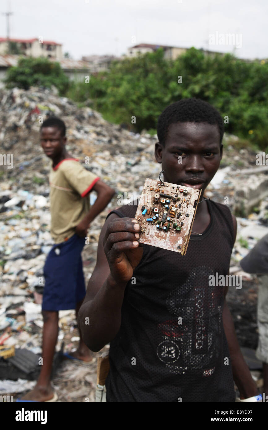 Electronic waste in Lagos, Nigeria. A boy is showing electronic waste, a circuit board, which can be found on the rubbish dump Stock Photo
