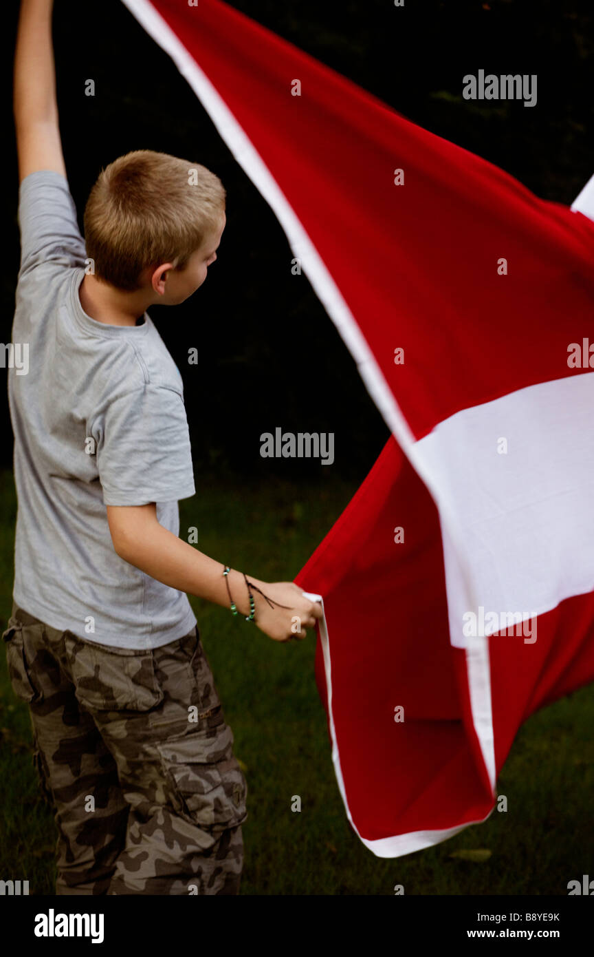 A boy and the Danish flag Denmark. Stock Photo