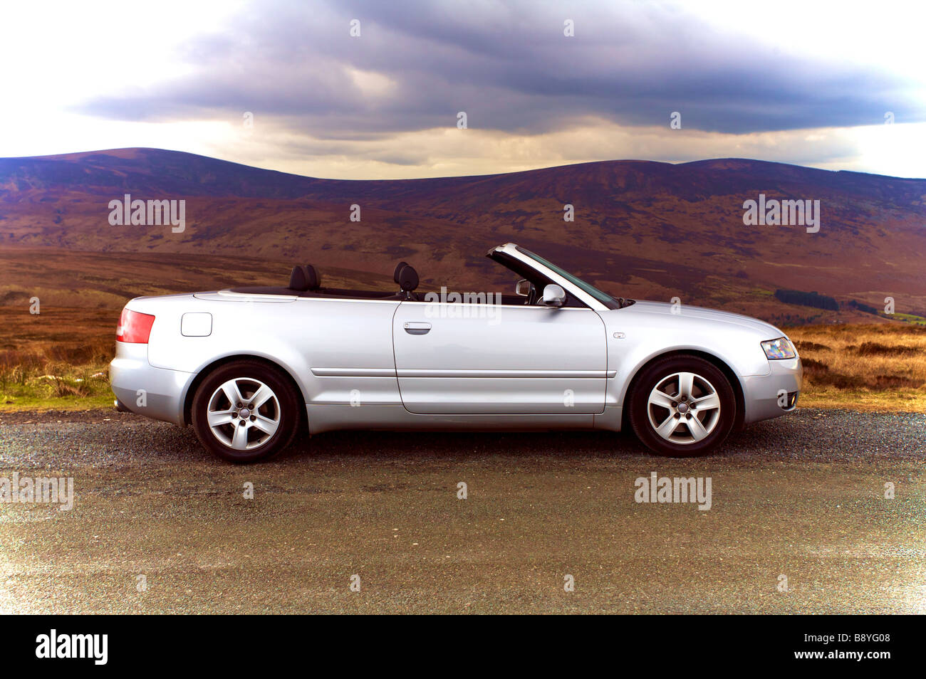 Silver Audi A4 1.8T Convertible roof coming down Stock Photo