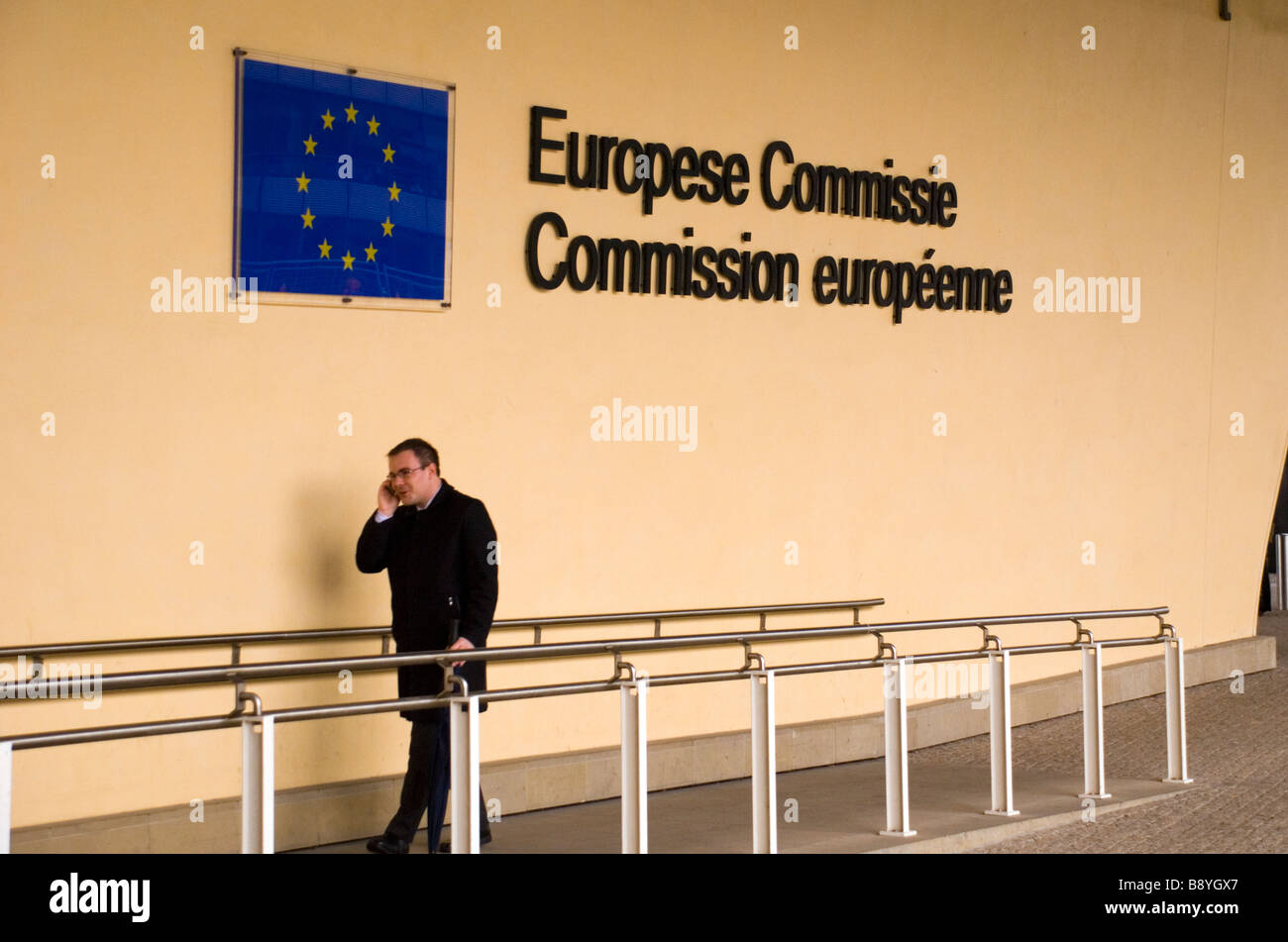 Berlaymont Brussels Belgium A man using a mobile phone outside the offices of the European Commission Stock Photo