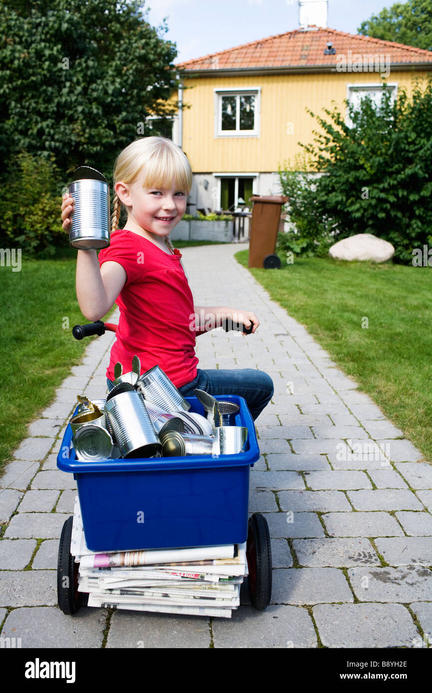 A girl with recycling objects on her bicycle Sweden. Stock Photo