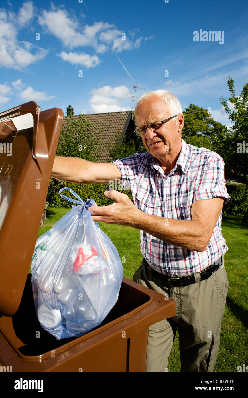 An elderly man by a dustbin Sweden. Stock Photo
