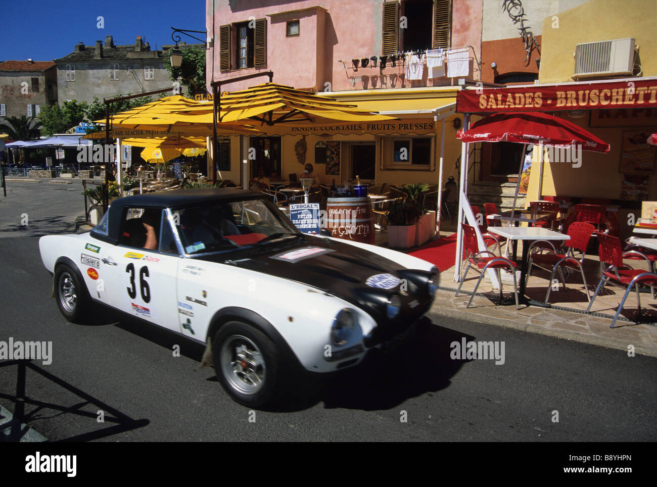 A Fiat Spider speeds through Corsica during a classic car rally Stock Photo