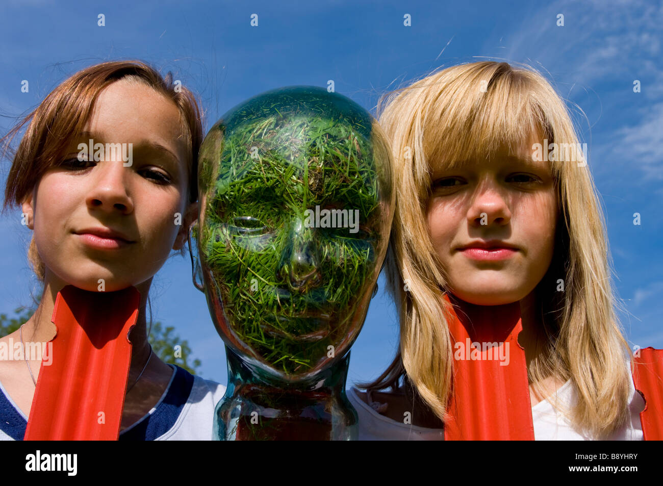 girls with Glass head grass filled Stock Photo