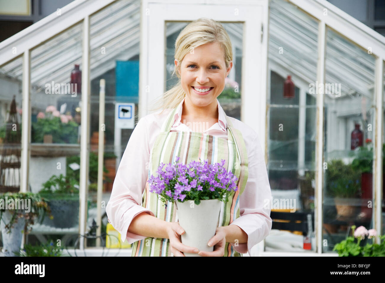 A blond woman working in a flower shop Sweden Stock Photo - Alamy