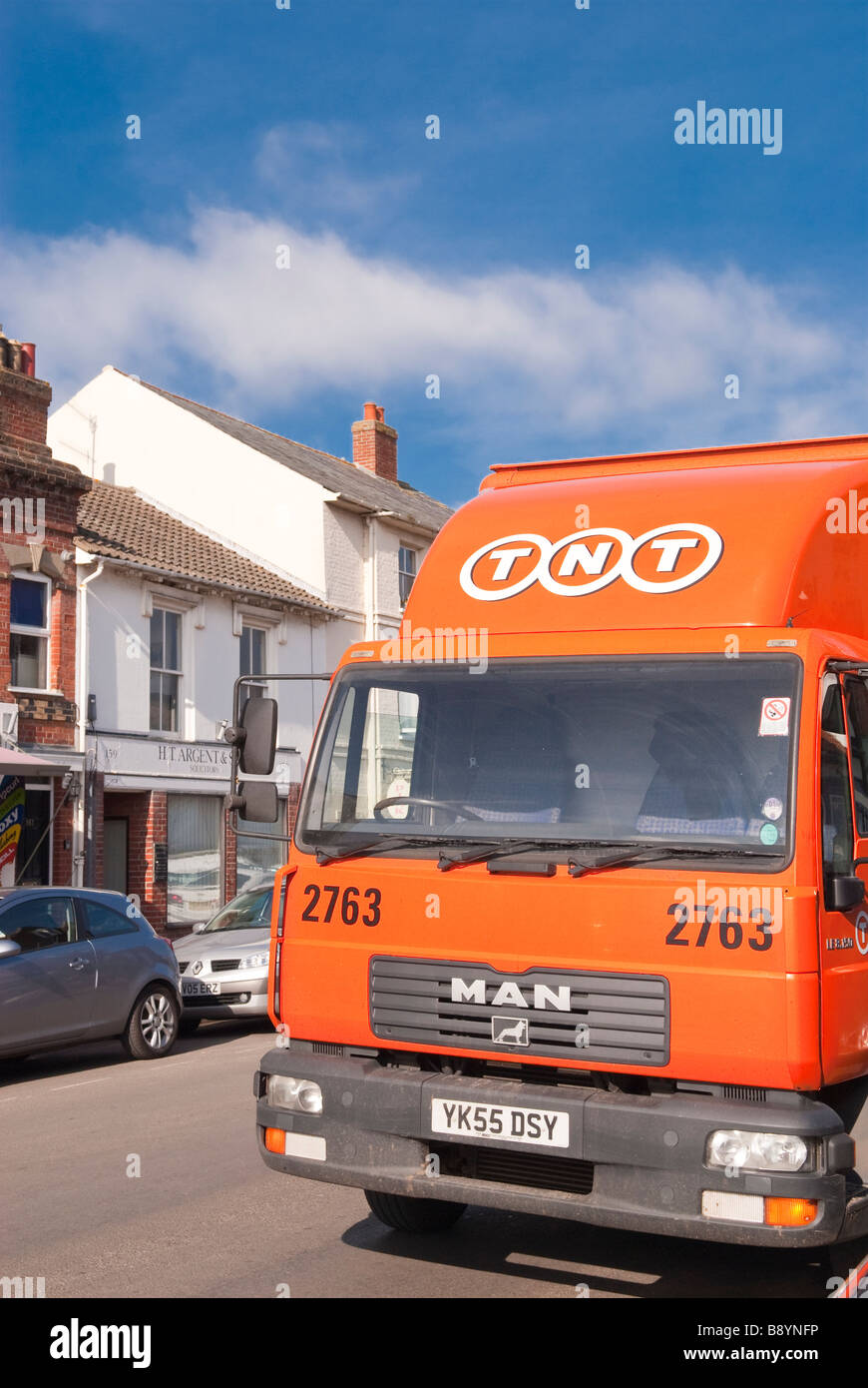 A TNT courier delivery lorry vehicle delivering parcels at work in a uk street Stock Photo