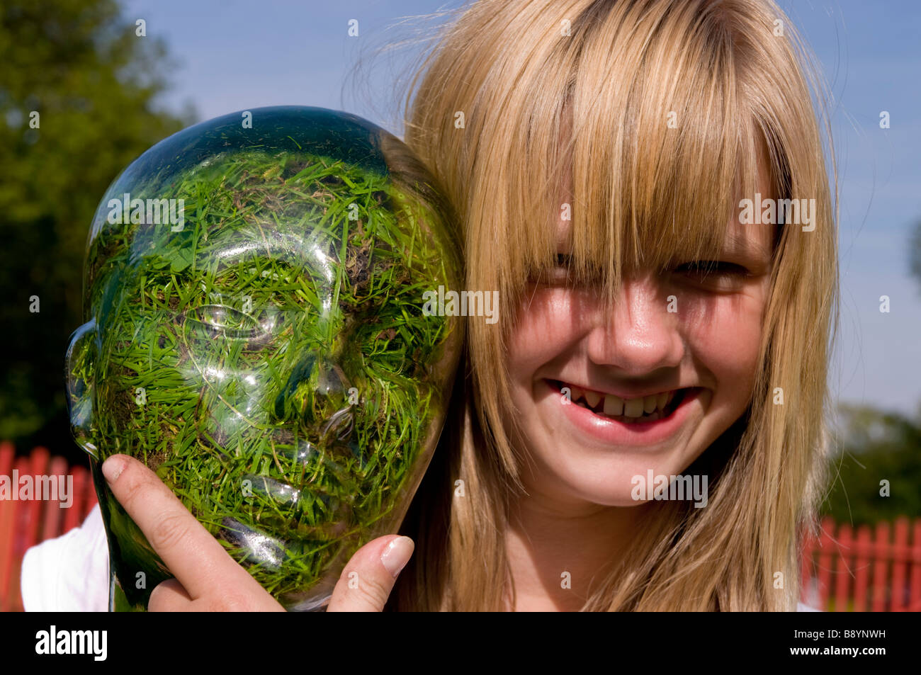 girl with Glass head grass filled Stock Photo