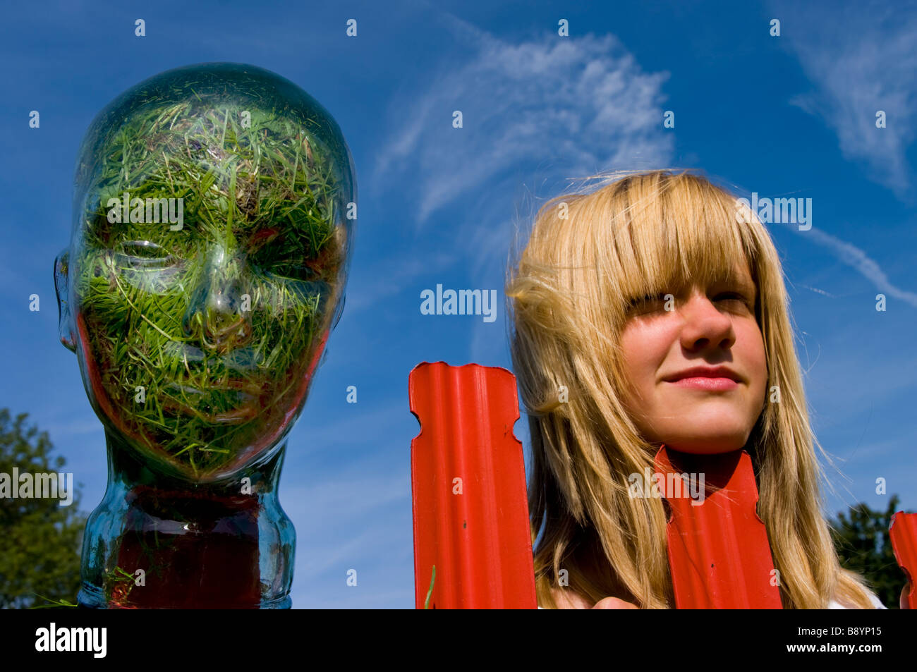 girl with Glass head grass filled Stock Photo