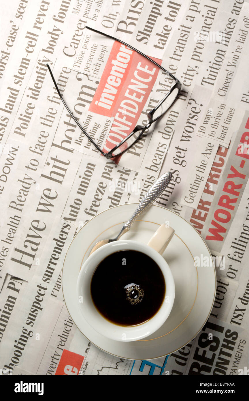 Coffee breakfast over top of bad news headlines in the newspaper Stock Photo