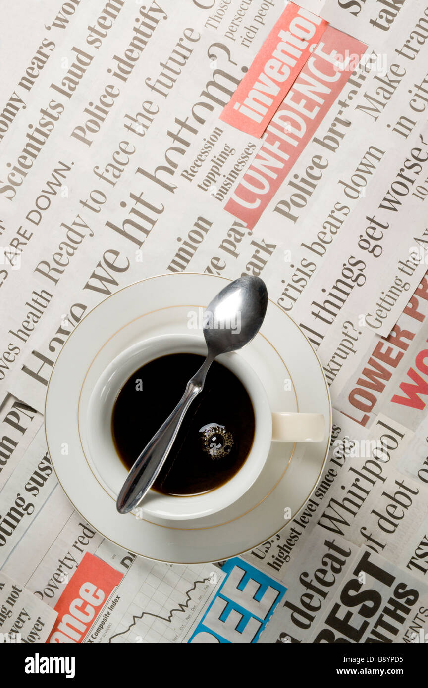Coffee breakfast over top of bad news headlines in the newspaper Stock Photo
