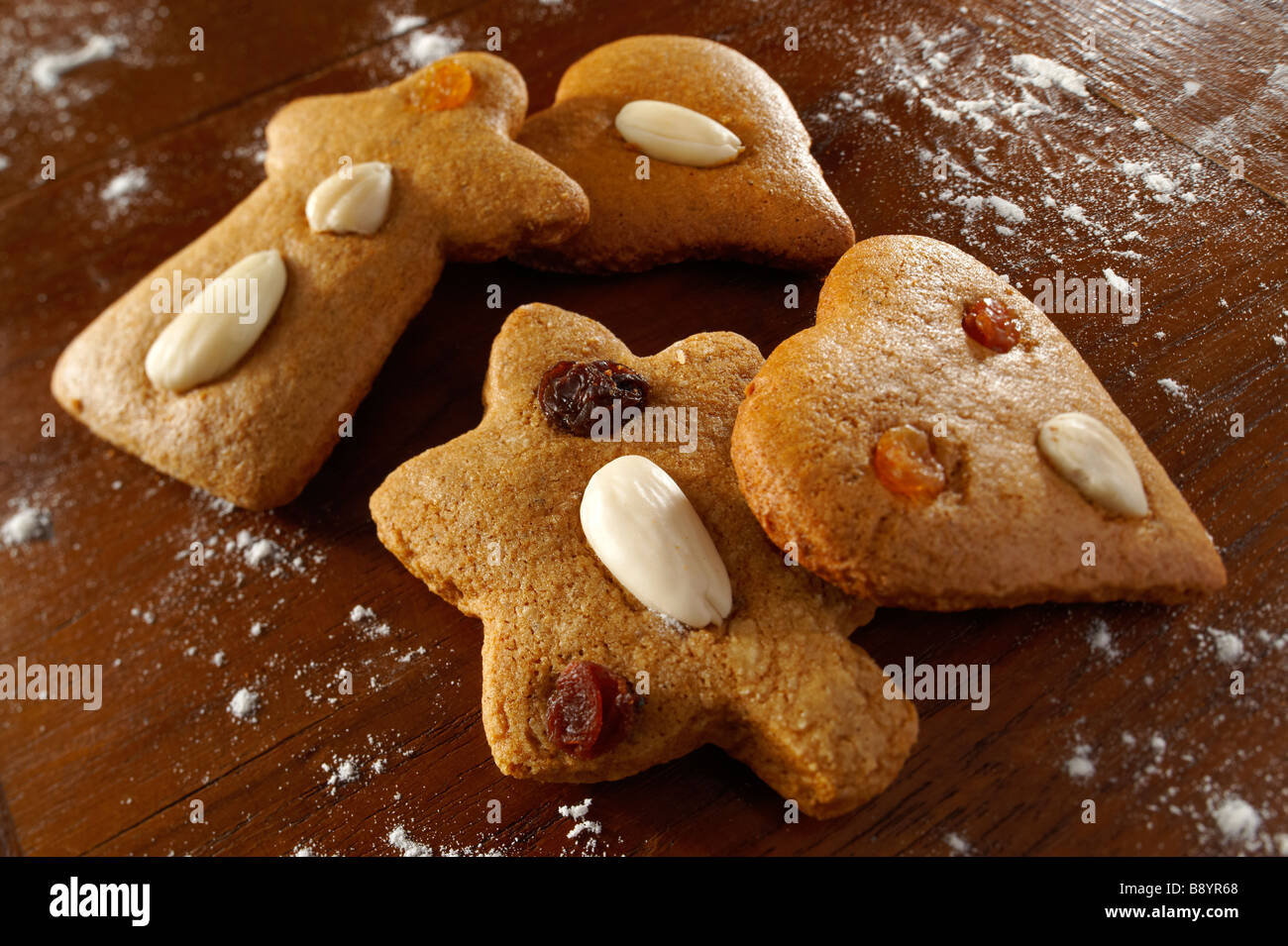Fresh baked spicy christmas biscuits in s festive setting on a wooden table Stock Photo