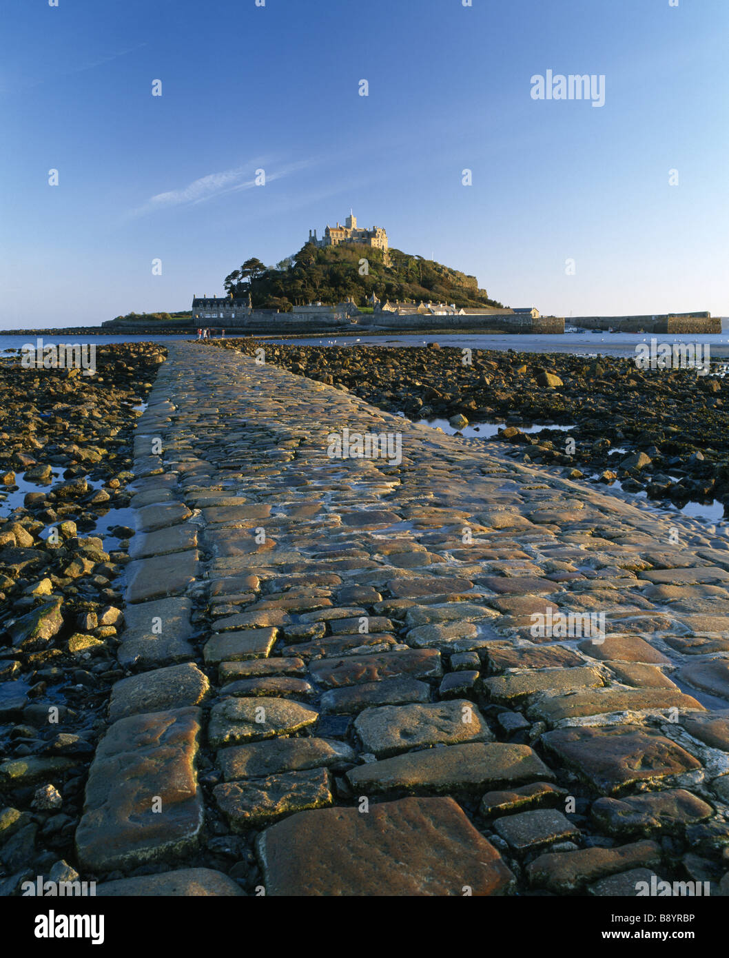 A view along the causeway at low tide looking out to St Michael s Mount in Cornwall Stock Photo