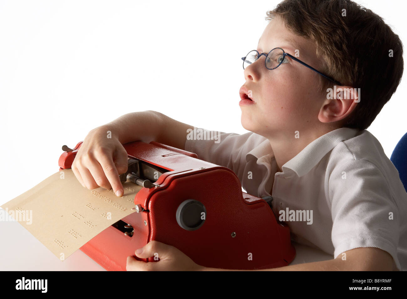 A visually impaired blind school boy struggling to use a braille