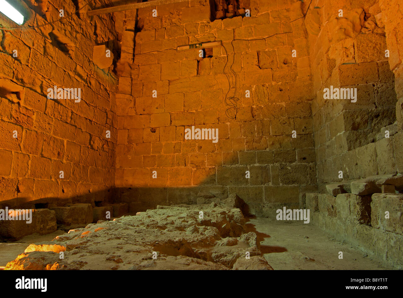 Stone masonry toilet seats still clearly identifiable communal latrine with tidal underground sewer in crusader fortress Acre Stock Photo