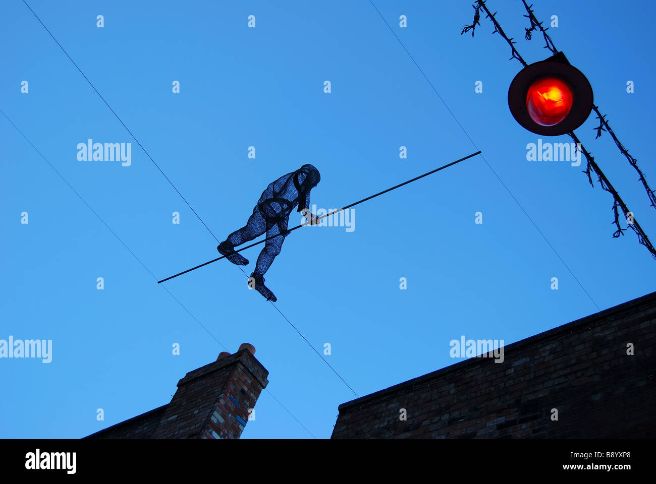 High-wire walker sculpture at dusk, SOL Square, Struthers lane, Christchurch, Canterbury, South Island, New Zealand Stock Photo