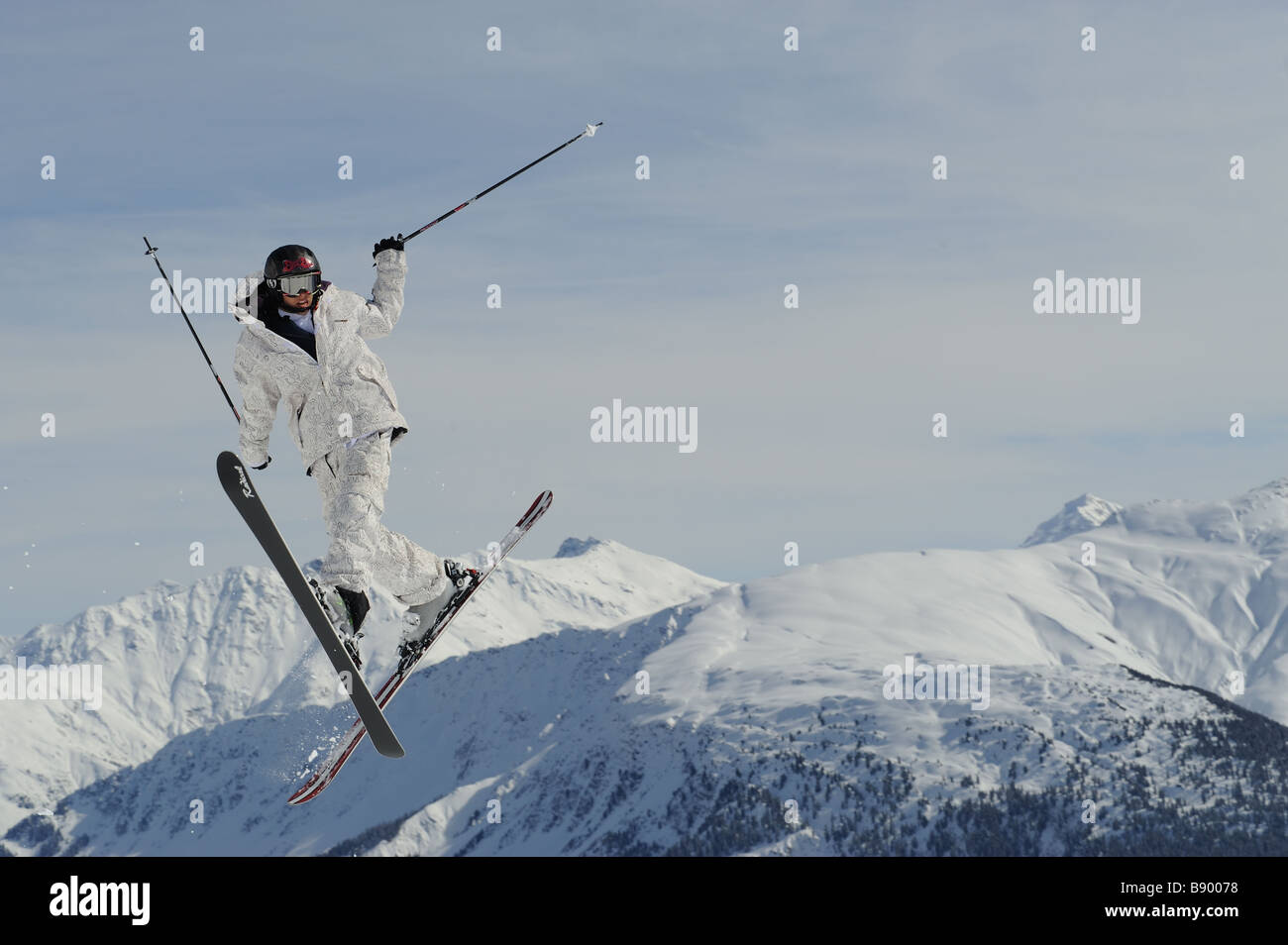 Freeskier jumping wildly into the skies in the swiss alps Stock Photo