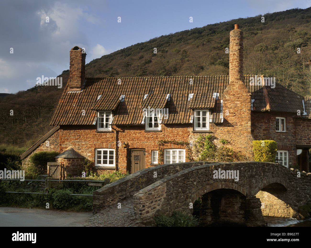 Packhorse Cottage, the warm red sandstone building in Allerford on the