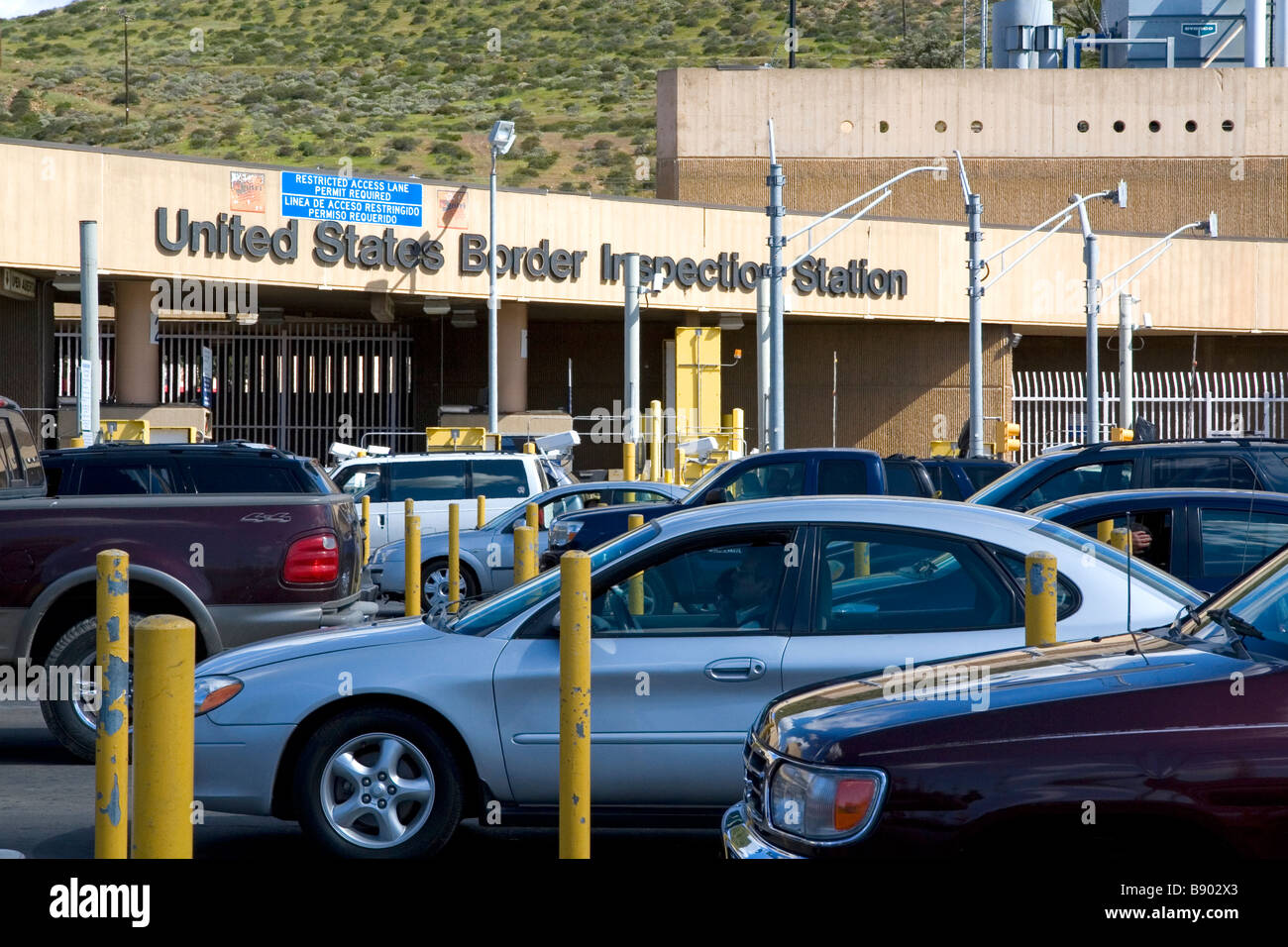 Automobiles wait to enter the United States port of entry at the Tijuana Baja California Mexico San Diego California border Stock Photo