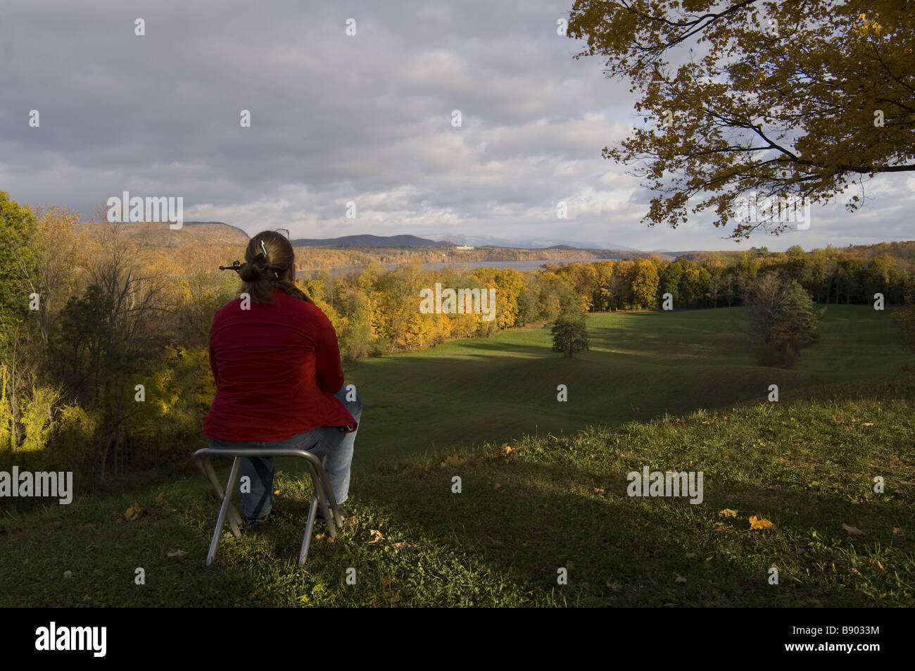 Woman looks out over Hudson River Valley vista at Vanderbilt Mansion, Hyde Park, New York Stock Photo