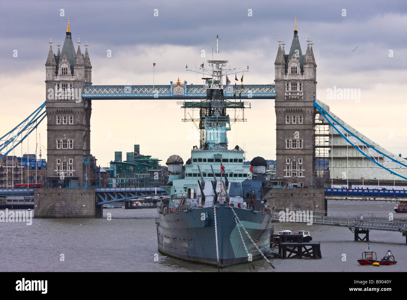 HMS Belfast warship in front of the London Tower Bridge Stock Photo
