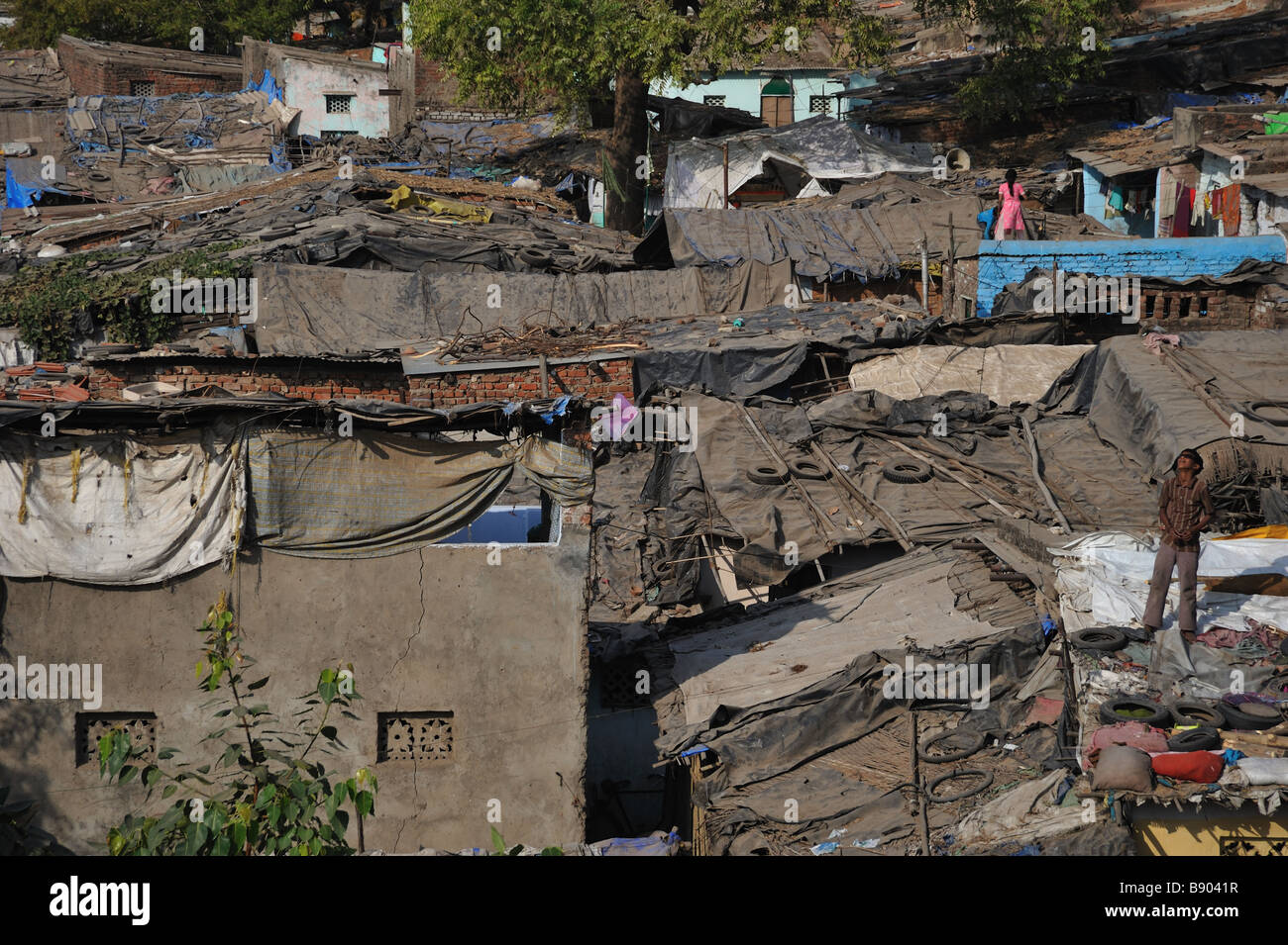 Children standing on the roofs of slum dwellings in Hyderabad, India. Stock Photo