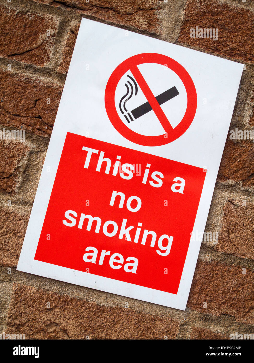 No Smoking sign on a red brick wall. Stock Photo
