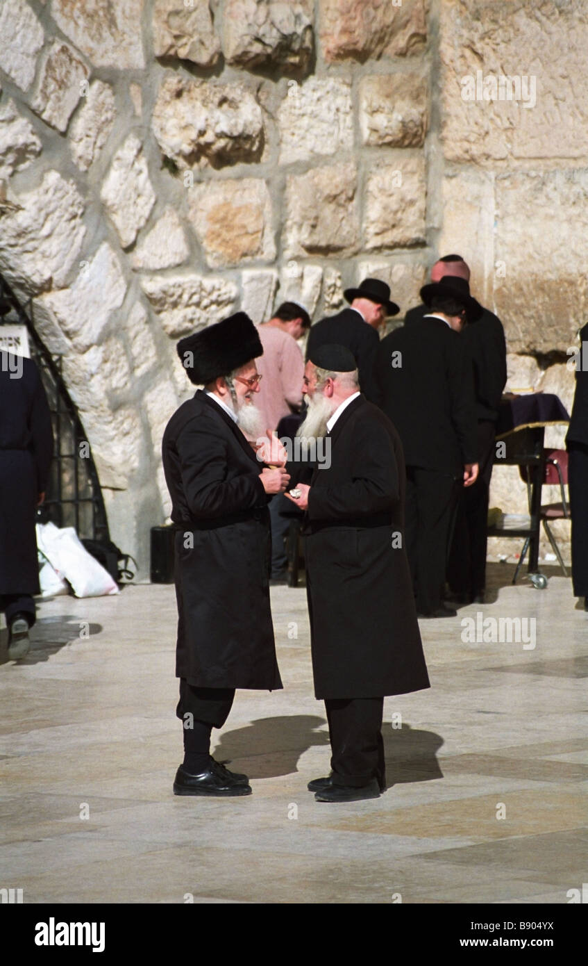 Orthodox Jews chat near the wailing wall in the old city of Jerusalem. Stock Photo
