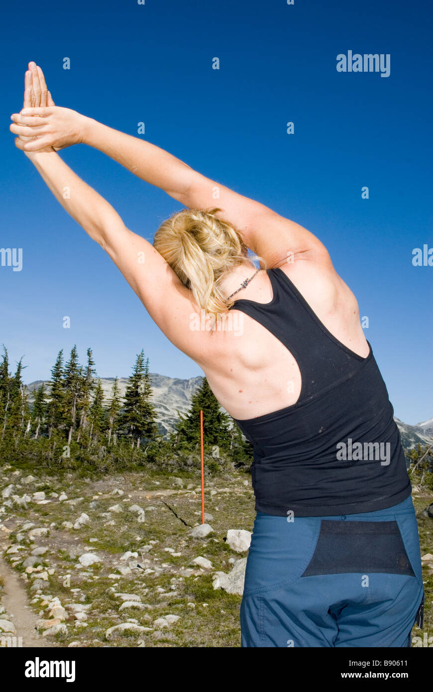 Young woman outside in the wilderness with back facing camera and