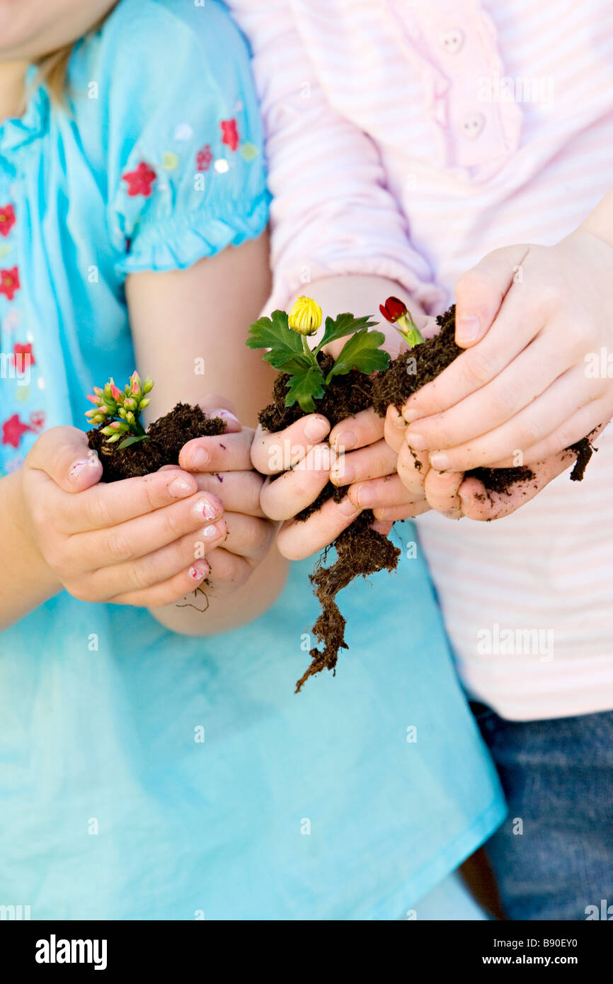 Two girls holding flowers. Stock Photo