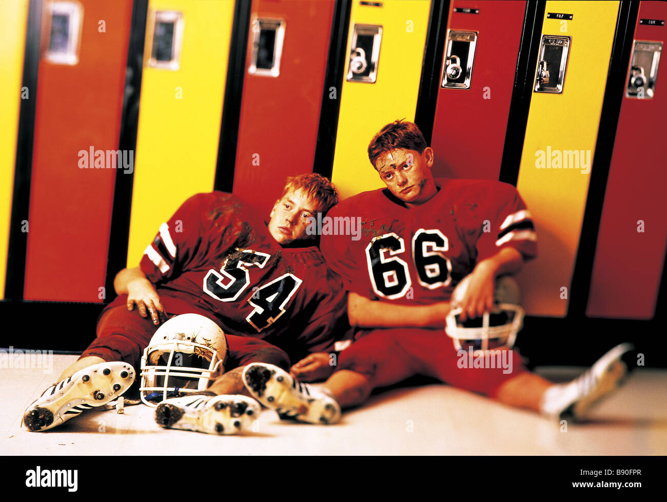 FL2768, MAD COW STUDIO; Dejected football players sitting  lockers Stock Photo