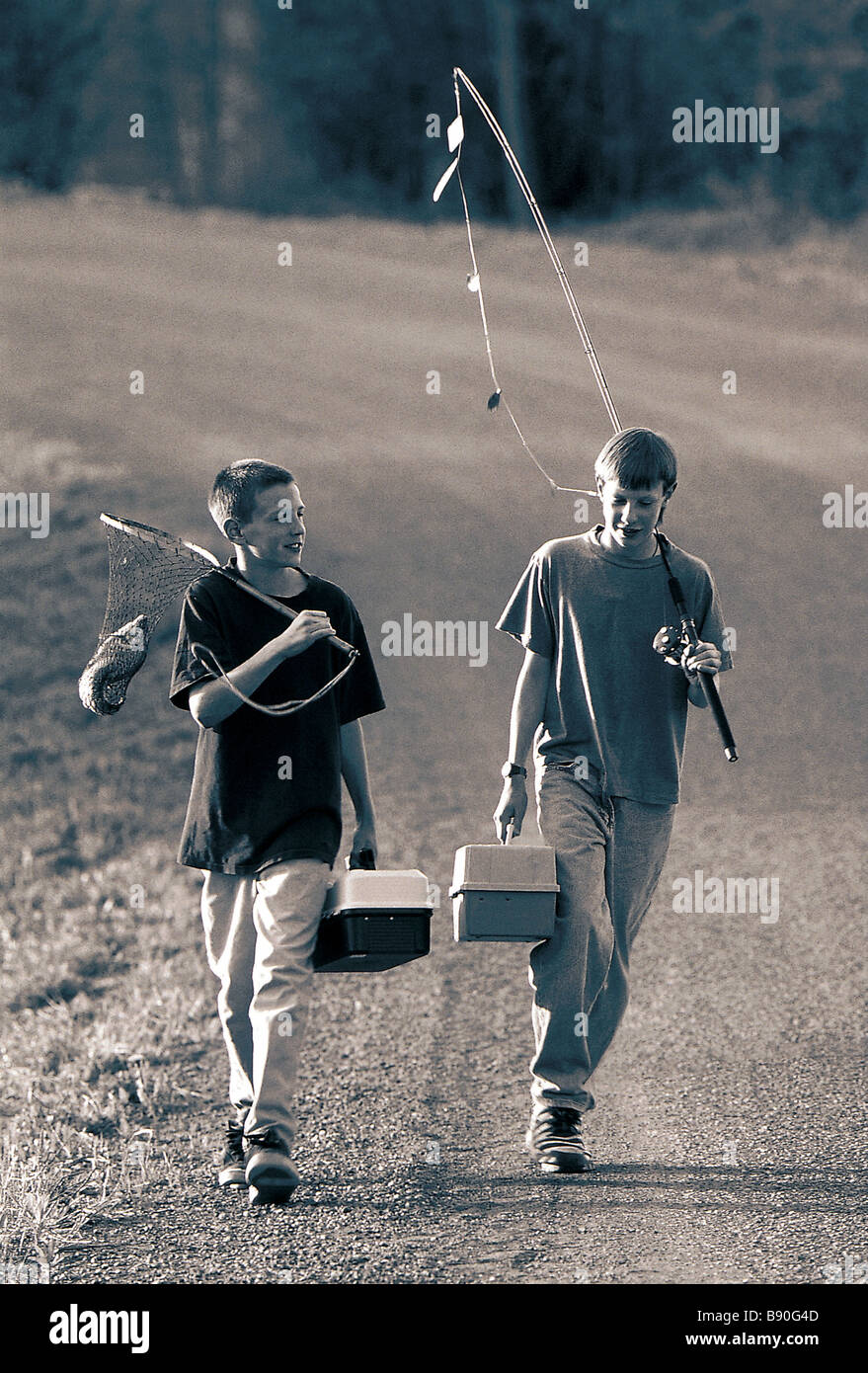 FL2837, DARWIN WIGGETT; Two boys walking fishing gear Stock Photo